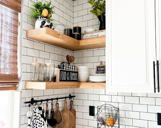 the kitchen is clean and ready for us to use it's shelves are filled with pots, pans, and utensils