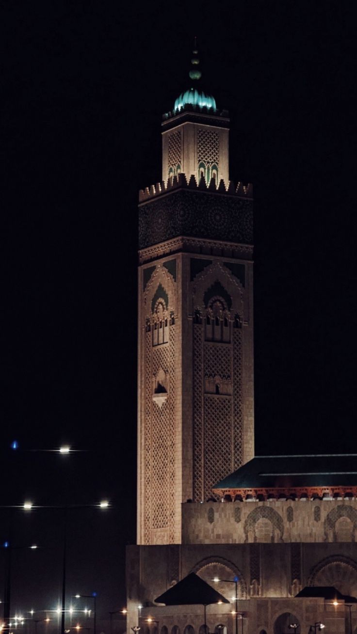 a tall clock tower lit up at night