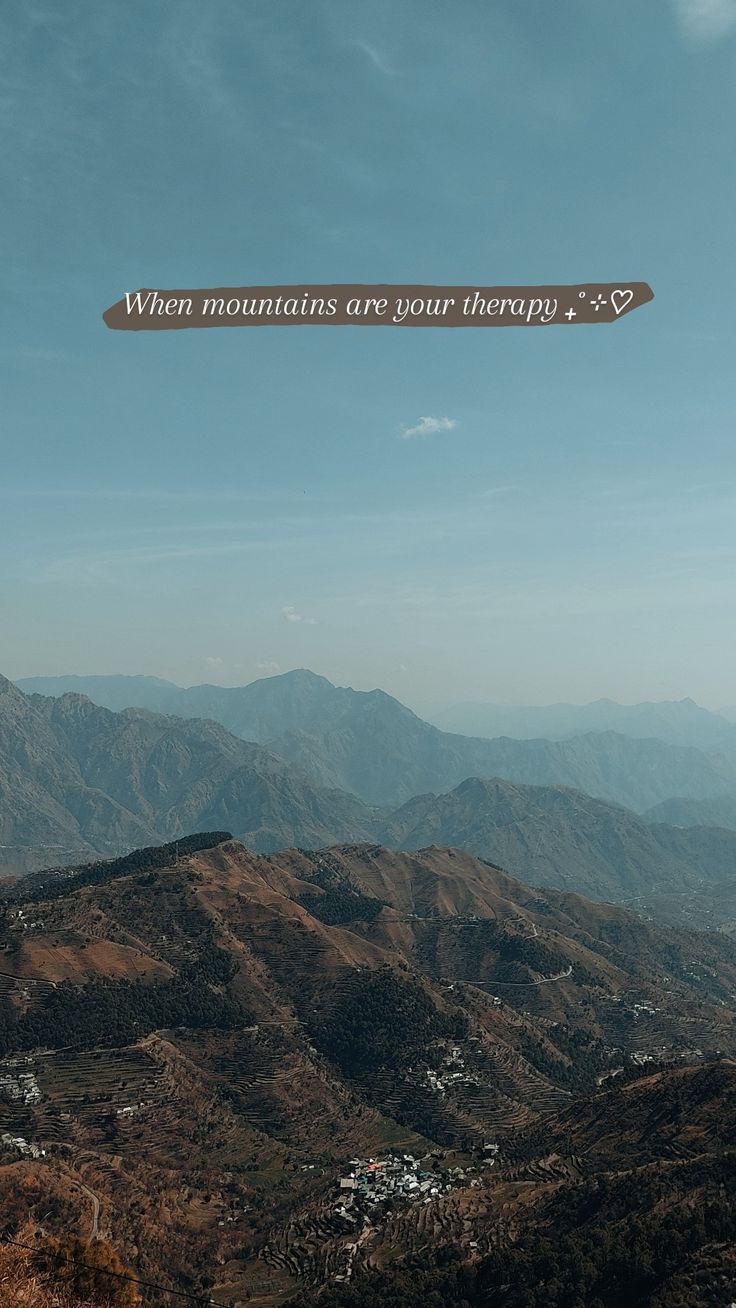 an aerial view of mountains with a quote above them