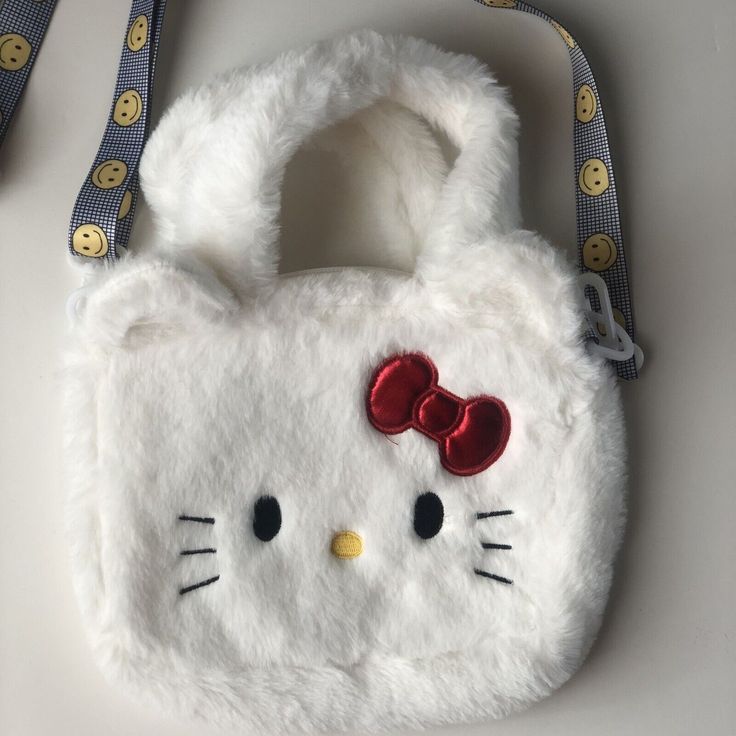 This Adorable Hello Kitty Crossbody Bag Is Perfect For Any Fan Of The Beloved Cartoon Character. Measuring 9 Inches In Width, 7 Inches In Height, And 6 Inches In Depth, It Provides Ample Space For All Your Essentials. The Bag Features A Zip Closure And Is Made Of High-Quality Materials, With A White Exterior And Matching White Hardware. The Plush Material Adds A Fun Touch To The Bag's Design, And The Cute Hello Kitty Logo Is Sure To Turn Heads. Ideal For Women Of All Ages, This Crossbody Bag Can Cute White Shoulder Bag With Animal Design, Cute White Shopping Bag, Cute Animal Design Pouch Bag, Cute Shoulder Bag With Cat Design, Cute Cat Design Satchel Bag, White School Shoulder Bag With Animal Design, White Portable Kawaii Bag, Trendy Hello Kitty Pouch Bag, Cute White Bag With Animal Design