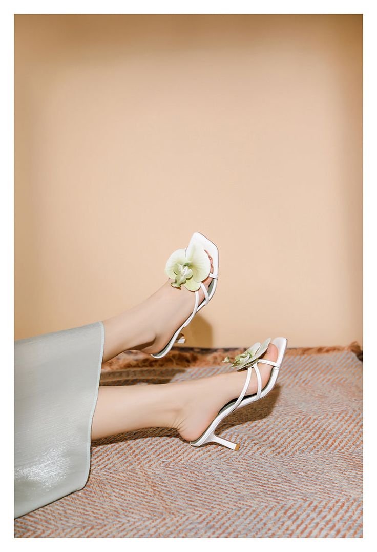 Helene Floral Heels in Green Helene is a graceful fusion of elegance and charm, crafted to elevate your style effortlessly. These heels feature delicate floral embellishments that bring a touch of nature-inspired beauty to your ensemble. The soft white color, combined with the intricate strappy design, exudes sophistication and refinement. Perfect for weddings, garden parties, or any event where you want to make a lasting impression, the Helene Floral Heels are a beautiful addition to any wardrobe. Details: - Delicate floral embellishment- Strappy design- Mid-height heel (7cm)- Square toe- Soft white color- Good Girl Things Elegant Days Collection Chic Summer Wedding Shoes, White Pointed Toe Sandals For Spring, White Sandals With 4-inch Heel For Spring, Spring Cream Open Toe Kitten Heels, Cream Open Toe Kitten Heels For Spring, Chic Summer Wedding Heels, Spring Wedding Shoes With Ankle Strap, Elegant White Heels With 4-inch Heel, Elegant Summer Wedding Shoes With Heel Strap