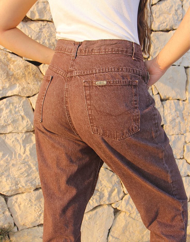 Mom jeans in brown. High rise. Zipper fly. Front and back pockets. Tapered leg. Size EU 40 / UK 12 Actual measurements - 30"(76cm) waist - 40"(102cm) hips - 30.5"(77cm) inner leg - 13"(33cm). Composition - 100% Cotton Condition - Excellent. Sustainability - Vintage Handpicked, repaired and ready to wear. This is an original vintage item, not new and minor signs of wear and age are expected, we will highlight any major flaws. Model is a size UK 6/8 and is 5'7" tall Brown Straight Leg Jeans With Belt Loops, Brown Jeans With Belt Loops For Fall, Brown Fall Jeans With Belt Loops, High Rise Brown Cargo Pants, Brown High Waist Cotton Jeans, High Waist Brown Cotton Jeans, Brown Straight Leg Bottoms With Belt Loops, Brown Straight Leg Denim Jeans, High Waist Brown Jeans With Pockets