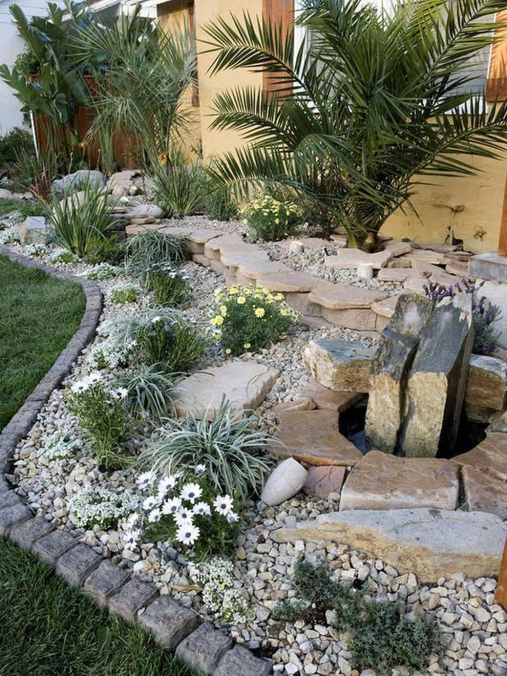 a garden with rocks and plants in it