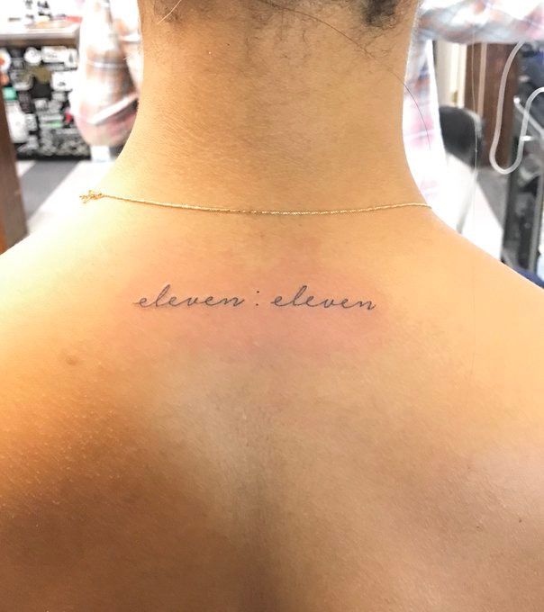 the back of a woman's neck with an inscription that reads, heaven eleven