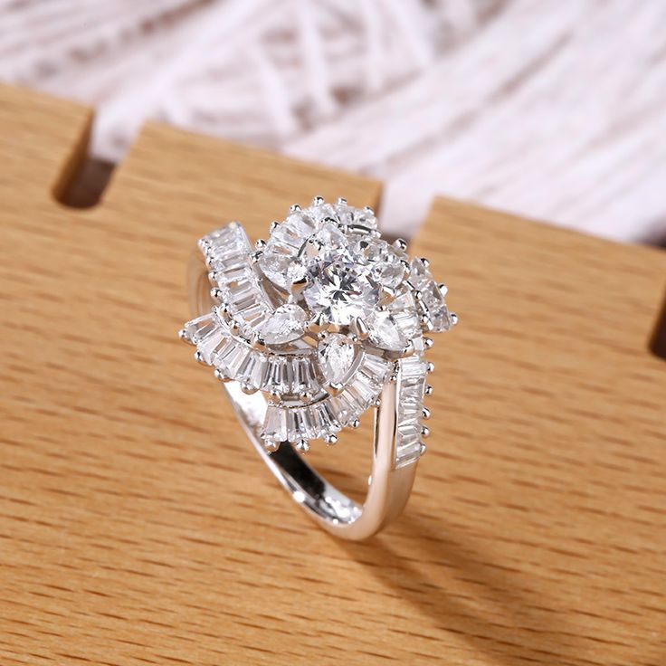 a diamond ring sitting on top of a wooden table