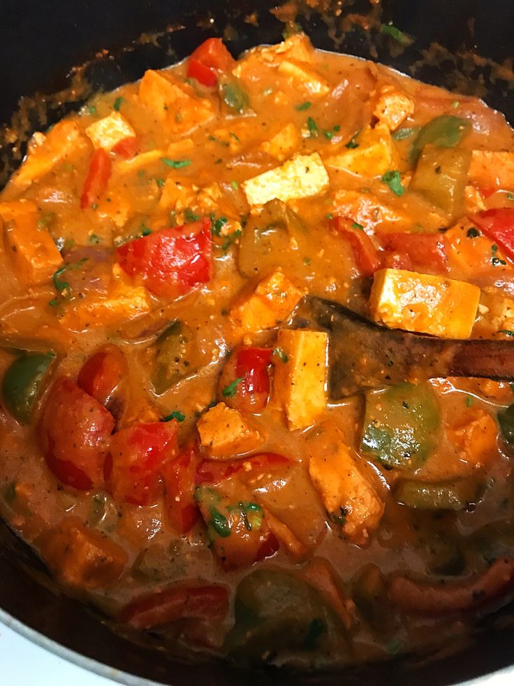 a pan filled with food sitting on top of a stove