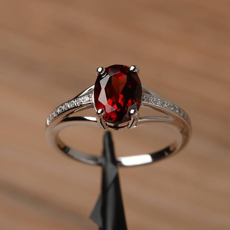 It is a natural garnet ring. The main stone is 7mm*9mm oval cut, weight about 2.33 carats. The basic metal is sterling silver and plated with rhodium. To change the metal to a solid gold (white/rose) or platinum is also available, please ask for a quotation if you want. You can also go to my shop Home for more elegant rings: https://www.etsy.com/shop/godjewelry?ref=hdr_shop_menu More rings: https://www.etsy.com/shop/godjewelry?ref=l2-shop-header-avatar Customization is always welcome and please Elegant Oval Garnet Birthstone Ring, Silver Oval Ring With Lab-created Ruby, Silver Oval Lab-created Ruby Ring, Silver Oval Garnet Birthstone Ring, Oval Garnet Ring In Silver, Oval Silver Garnet Birthstone Ring, Oval Silver Ruby Promise Ring, Oval Garnet Birthstone Ring In Silver, Oval Garnet White Gold Jewelry