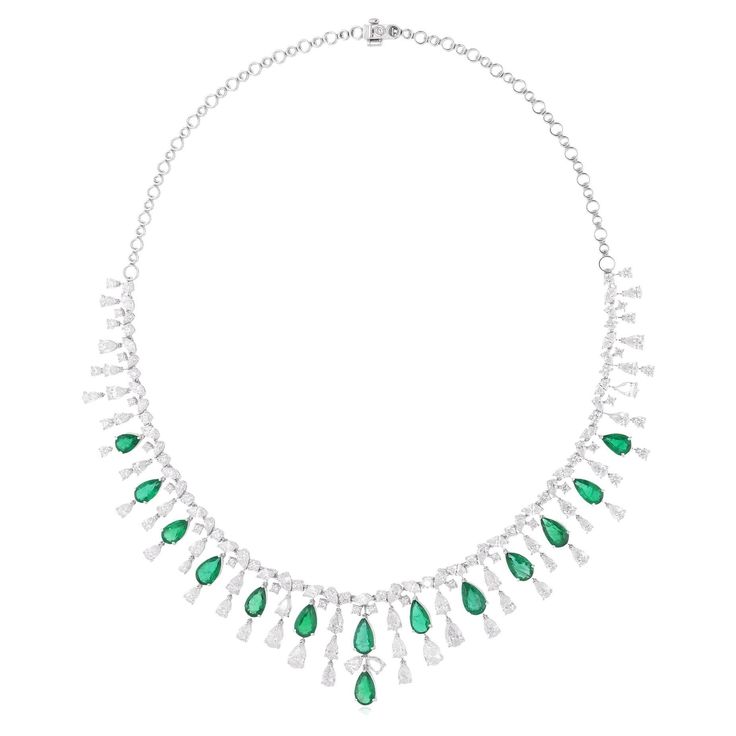 Surrounding the emerald are shimmering Diamonds, meticulously set in a halo design. These Diamonds, chosen for their exceptional brilliance and fire, add a touch of luxury and glamour to the necklace, enhancing the beauty of the emerald with their radiant sparkle. Item Code :- SEN-51229 Gross Wt. :- 39.66 gm 18k White Gold Wt. :- 33.66 gm Natural Diamond Wt. :- 18.58 Ct. ( AVERAGE DIAMOND CLARITY SI1-SI2 & COLOR H-I ) Zambian Emerald Wt. :- 11.42 Ct. Necklace Length :- 16 Inches Long ✦ Sizing .. Real Diamond Necklace, Antique Necklaces, Halo Design, White Gold Set, Necklace Diamond, Zambian Emerald, Expensive Jewelry, Antique Necklace, Emerald Gemstone