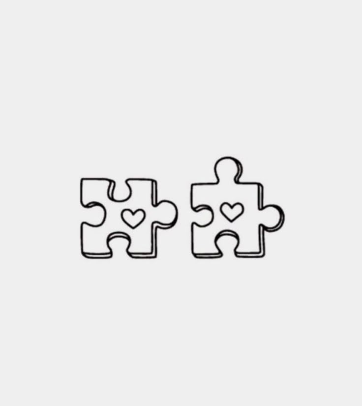 two puzzle pieces with hearts on them