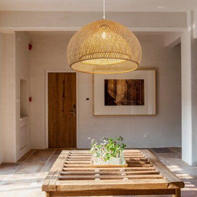 a wooden table sitting under a light fixture in a living room