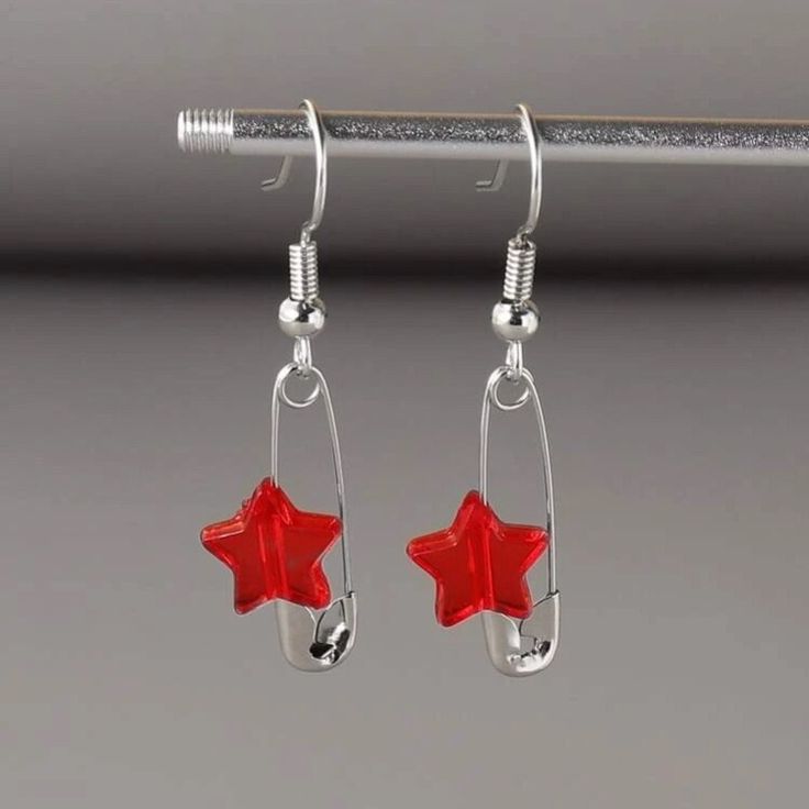 This Pair Of Safety Pin Star Dangle Drop Earrings Is A Wonderful Addition To Your Wardrobe And Your Style! This Fun And Cute Piece Is Sure To Get Lots Of Compliments! Red Star Charm Earrings For Gift, Red Star-shaped Nickel-free Earrings, Nickel-free Red Star Earrings, Red Star Charm Earrings, Red Star-shaped Earrings With Star Charm, Red Star Shaped Sterling Silver Jewelry, Red Star-shaped Earrings For Party, Red Star-shaped Sterling Silver Jewelry, Red Star-shaped Party Earrings