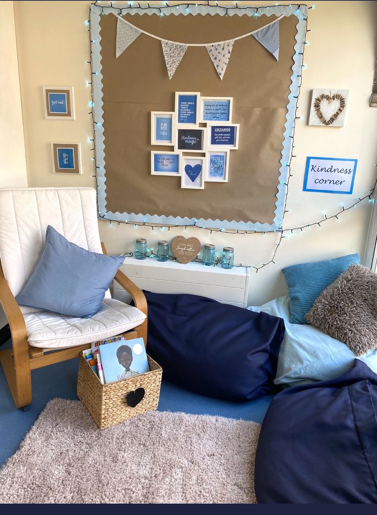 a living room with blue and white decor on the walls, pillows and blankets in front of a window