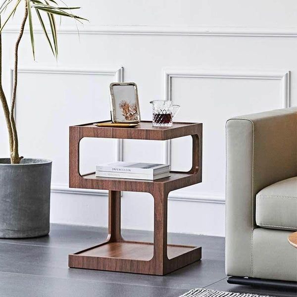 a living room with two chairs and a table in the corner next to a potted plant