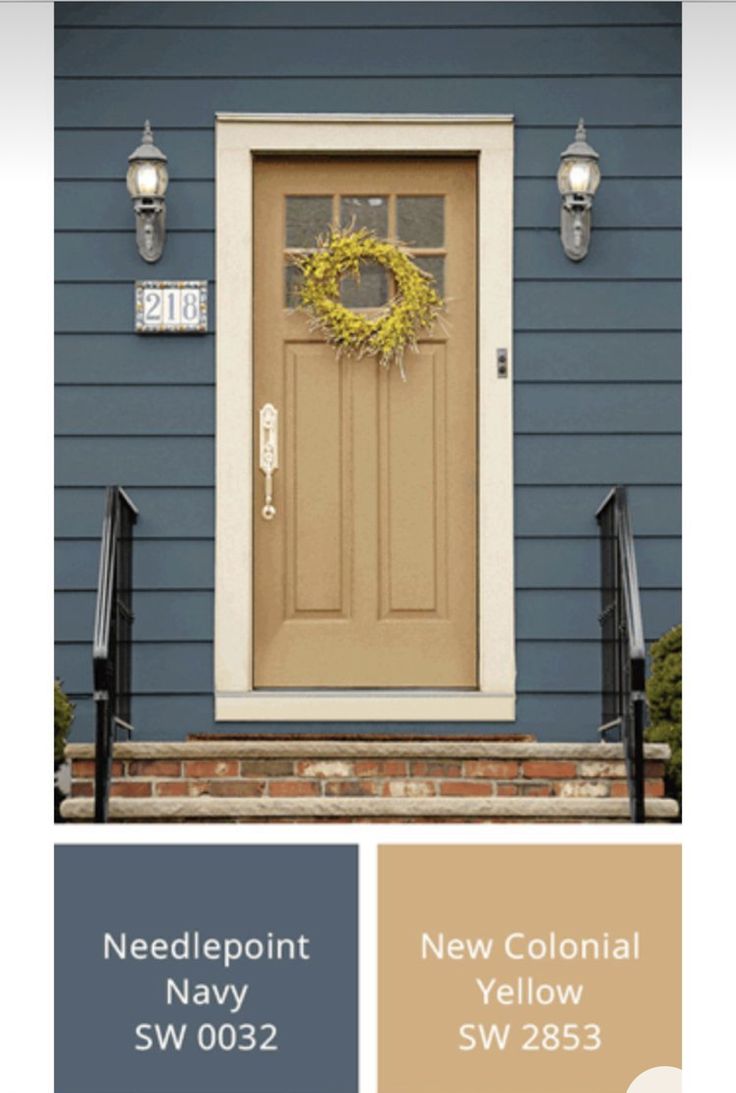 the front door is painted brown and has a yellow wreath hanging from it's side