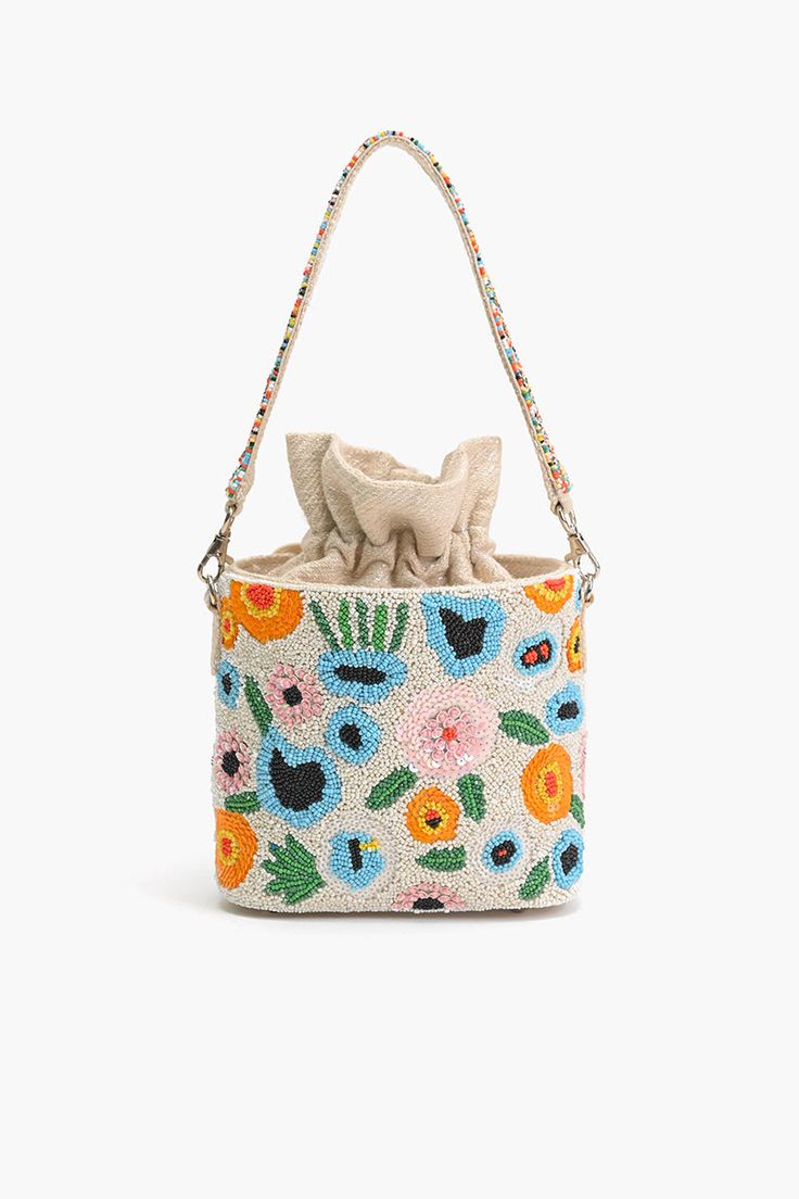 All Over Embellished bucket bag Silver-tone Hardware Drawstring fastening Metal Feet Single beaded top handle Size: 10" x 6.5" x 3.5" Step into a floral paradise with our exquisite Floral Paradise Bucket Bag, a true masterpiece of craftsmanship and elegance. This bucket bag is not just an accessory; it's a statement piece designed to captivate hearts and turn heads wherever you go.Adorned with all-over embellishments, each detail tells a story of timeless beauty and intricate artistry. The silve Spring Beach Bags With Beaded Details, Bucket Bag With Pearl Handle, Spring Evening Bucket Bag Tote, Spring Evening Tote Bucket Bag, Spring Beach Beaded Bags, Summer Bucket Bag Pouch With Detachable Handle, Beaded Bucket Shoulder Bag For Everyday Use, Summer Pouch Bucket Bag With Detachable Handle, Everyday Beaded Bucket Shoulder Bag