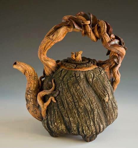 a teapot made out of wood and rope