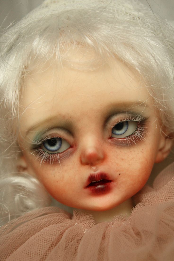 a doll with white hair and blue eyes