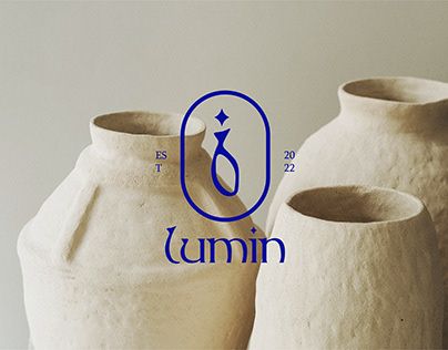 two white vases sitting next to each other with the word lumin on them