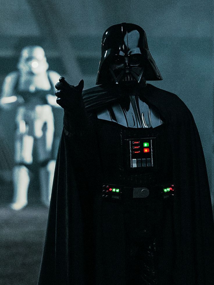 darth vader standing in front of two other characters