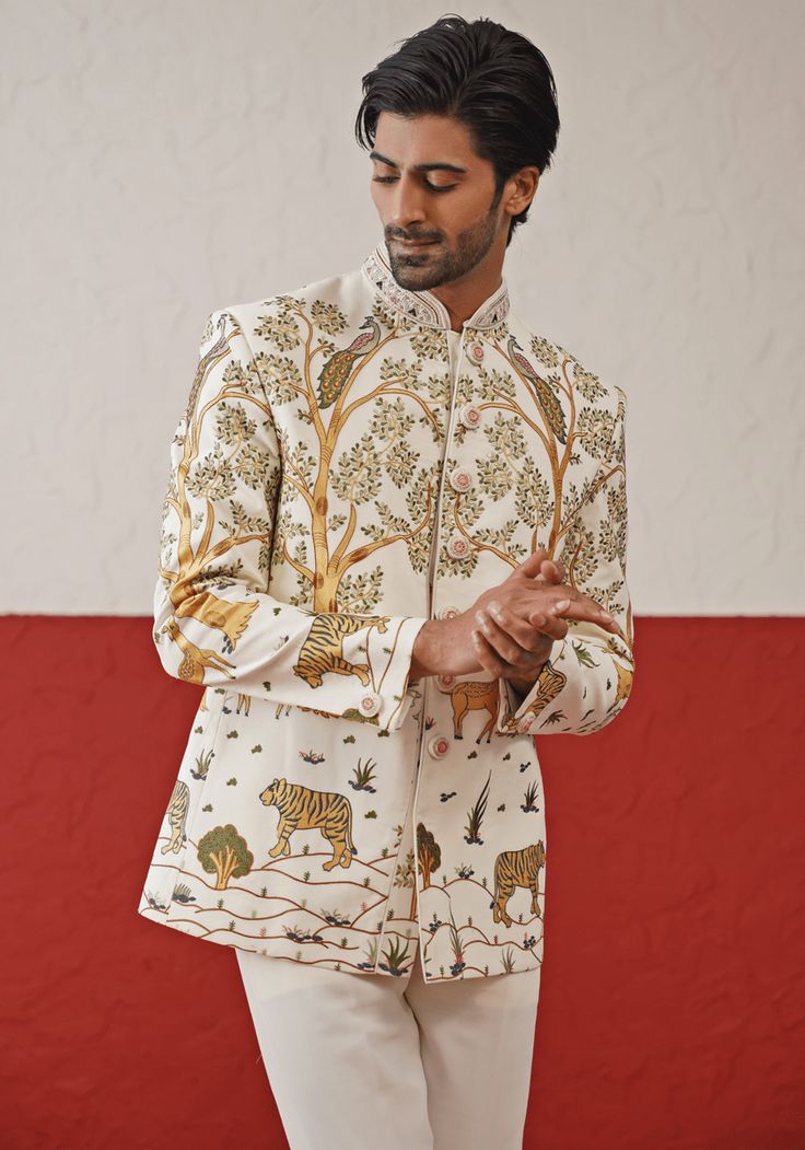 Step into sophistication with the Off White Jodhpuri suit. Crafted from georgette, the suit features a stunning multi-color resham and sequin work. The handwork on the collar and buttons adds an extra touch of elegance. Perfectly paired with matching pants. Perfect for special occasions like Sangeet, Mehendi, Haldi, or as a wedding guest outfit. Composition : Jodhpuri Jacket & Pant : Viscose Georgette Care: Dry Clean Only and Vacuum Storage This product can be customized for sleeves, length and Designer Bandhgala With Mirror Work And Long Sleeves, Designer Long Sleeve Bandhgala With Mirror Work, Designer Nehru Jacket With Mirror Work For Festive Season, Designer Nehru Jacket With Intricate Embroidery For Festive Occasions, Designer Long Sleeve Sets With Mirror Work, Designer Raw Silk Bandhgala With Mirror Work, Designer Embroidered Bandhgala For Festive Occasions, Designer Nehru Jacket With Mirror Work For Festivals, Designer Embroidered Raw Silk Bandhgala