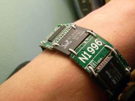 a close up of a person's arm wearing a bracelet made out of an electronic board