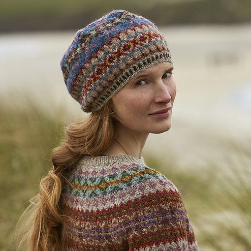 a woman wearing a multicolored knitted hat