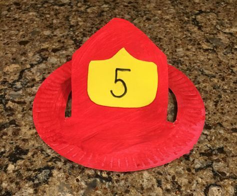 a red paper plate with a yellow number 5 on it sitting on top of a counter