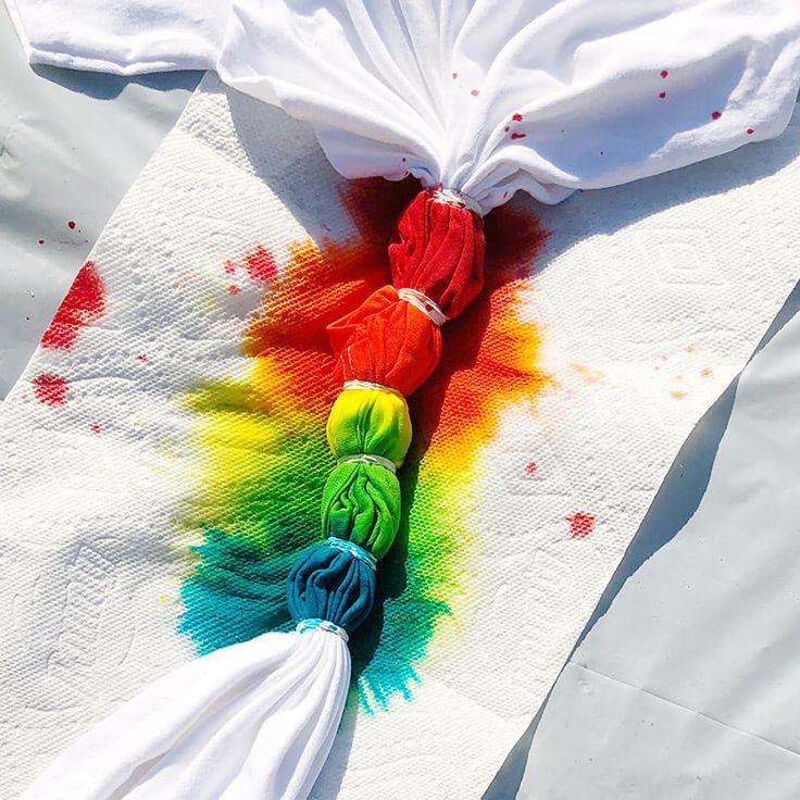 a white cloth with multicolored yarn on it