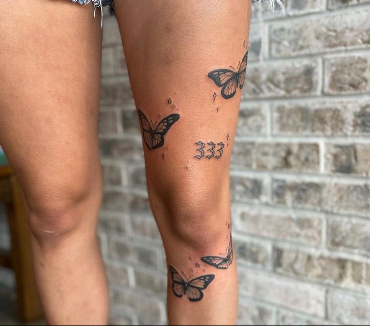 a woman's legs with butterfly tattoos on them and the bottom part of her leg