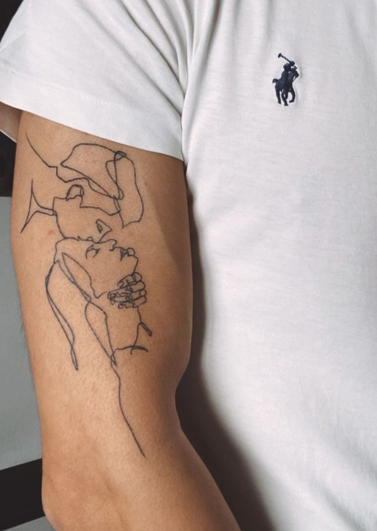 a man with a tattoo on his arm that has a horse drawn on the side