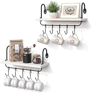 two white shelves with coffee cups and mugs hanging on the wall next to each other