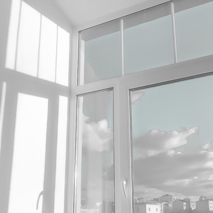 an open window with the sky in the background