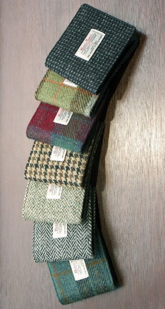 five ties are stacked on top of each other in different colors and patterns, with price tags attached to them