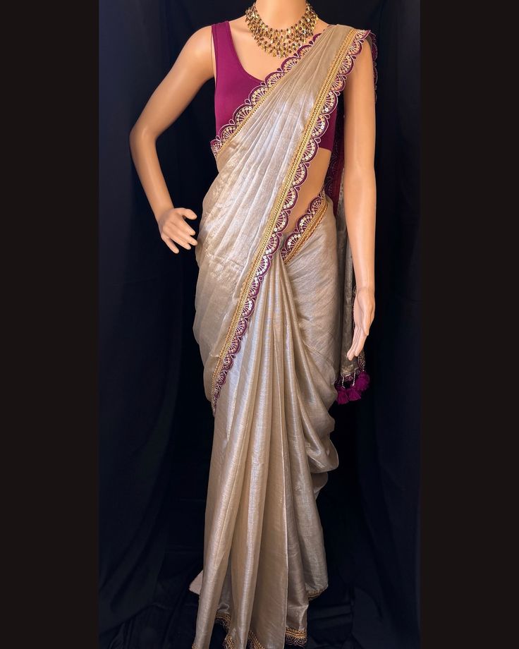 Silver mettalic tissue saree with contrast magenta golden lace all over sarees. Comes with beautiful big magenta thread tassels on pallu. Blouse: running blouse 80cm. To find this product in website: Www.thejacouture > Tissue sarees> silver mettalic tissue saree. Jewellery collaboration: @anvi__jewellery #mettalictissuesaree #silversaree #fancysaree #tissuesaree #trendingsaree #tissuelacesaree Silver Saree With Contrast Blouse, Silver Saree, Saree With Contrast Blouse, Tissue Sarees, Thread Tassels, Lace Saree, Saree Jewellery, Golden Lace, Tissue Saree