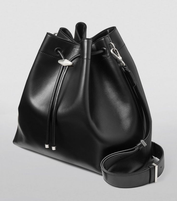 Find JIMMY CHOO Large Leather Cinch Bucket Bag on Editorialist. Bringing vintage influences firmly into the modern day, Jimmy Choo's Cinch bag sees a cloud-like pouch brought together by a drawstring fastening and suspended by way of a detachable shoulder strap. Clasp the perfectly formed accessory in your hand as you step out to your next engagement, and enjoy its capacious interior and slouchy aesthetic. Travel Bucket Bag With Silver-tone Hardware, Luxury Bucket Bag Satchel With Silver-tone Hardware, Travel Tote Bucket Bag With Silver-tone Hardware, Travel Tote With Silver-tone Hardware, Black Bucket Bag With Palladium Hardware, Everyday Bucket Bag With Silver-tone Hardware, Daily Use Bucket Bag With Silver-tone Hardware, Modern Bucket Bag With Palladium Hardware For Travel, Modern Travel Bucket Bag With Palladium Hardware