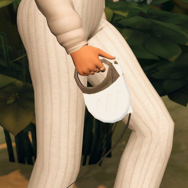 a woman in white pants holding an object with her right hand on the side of her leg