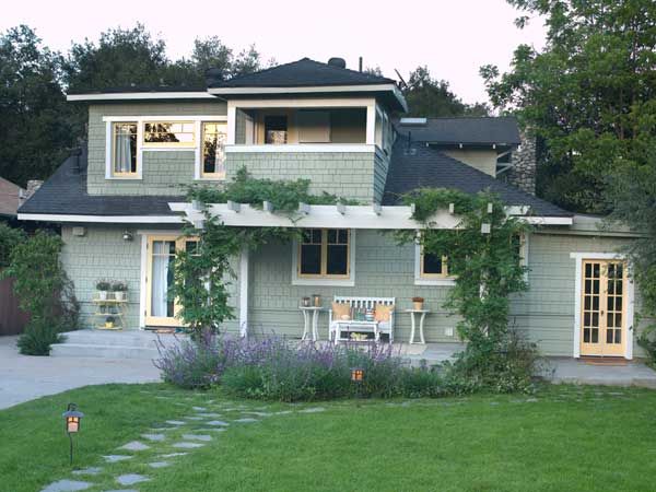 a large house with lots of windows and green grass