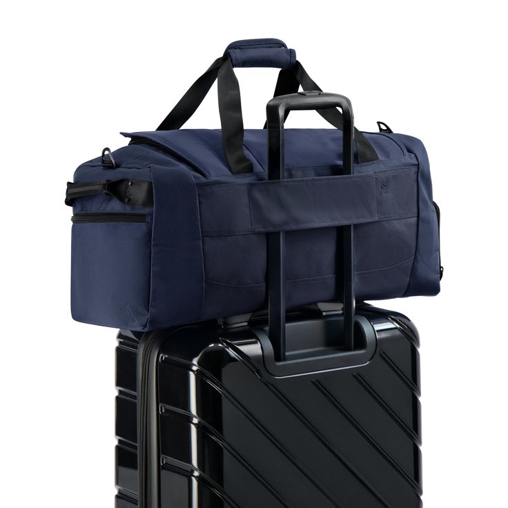 two pieces of luggage are stacked on top of each other, one is blue and the other is black