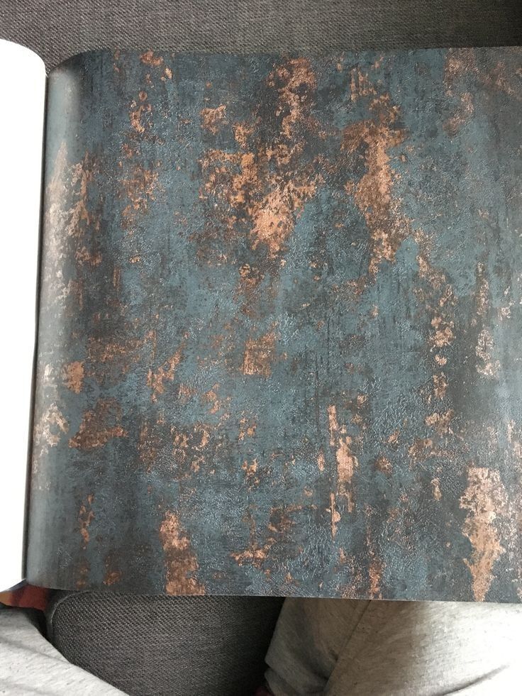 an open book with rust on it sitting on a couch