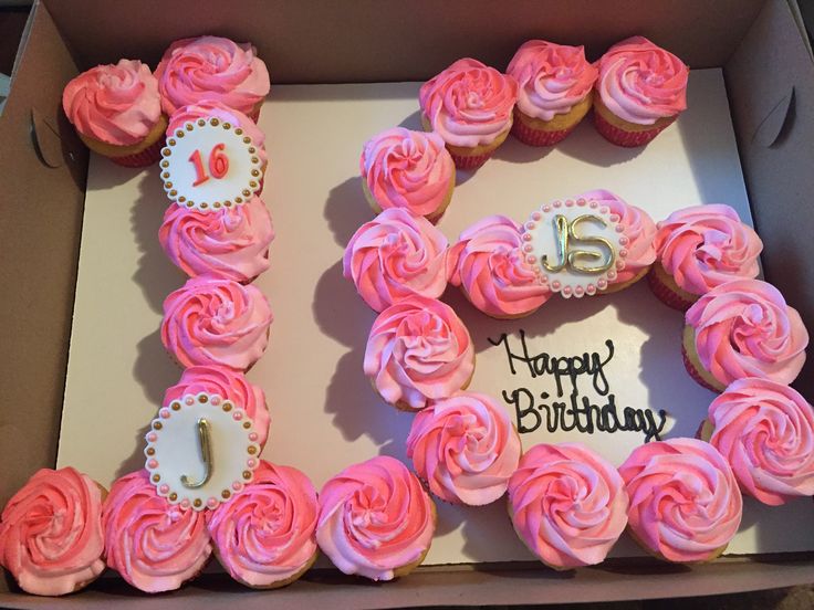 a birthday cake with pink frosting and roses in the shape of the number 15