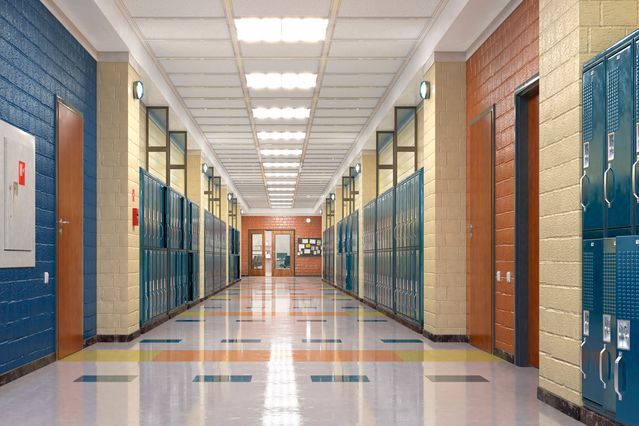 an empty hallway with blue and orange lockers