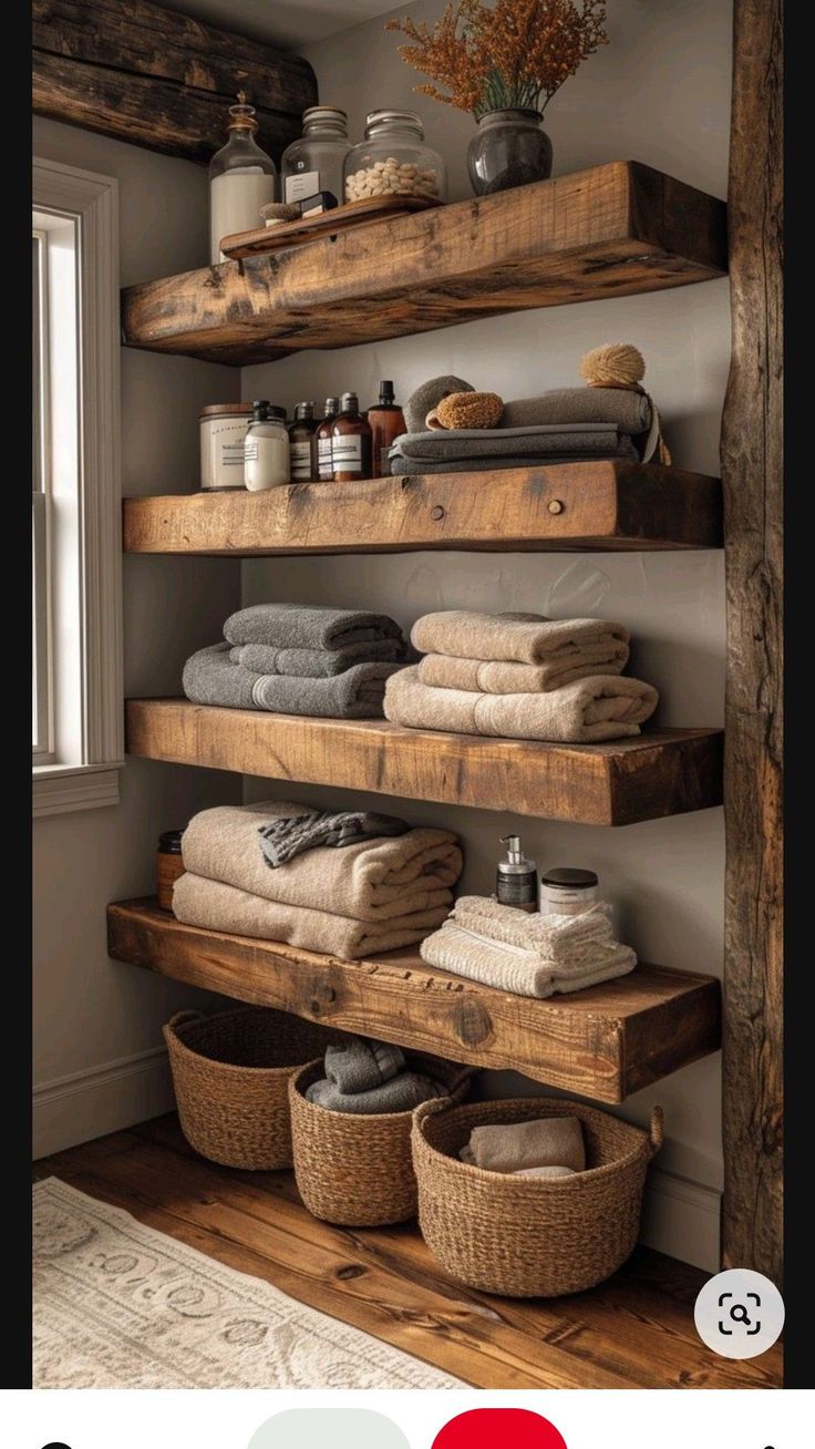 the shelves in this bathroom are made out of wooden planks and have towels on them