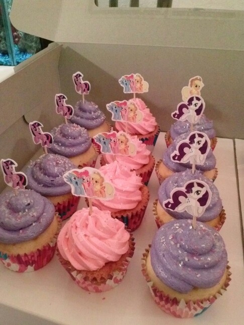 there are many cupcakes with purple frosting