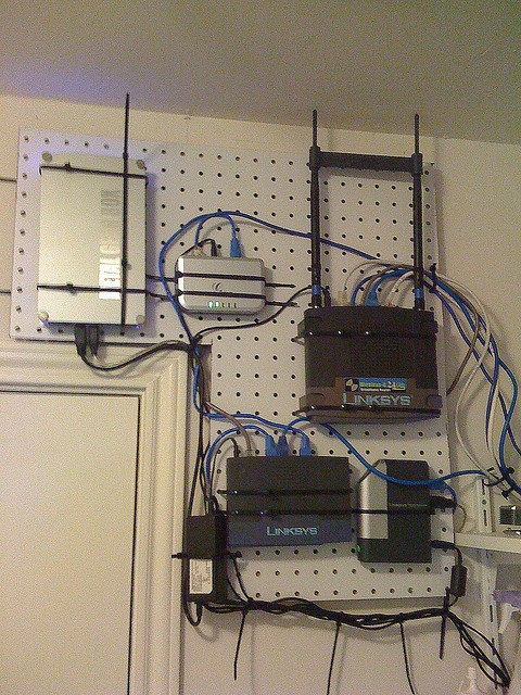 several electronic devices are connected to each other on a pegboard with wires and cords