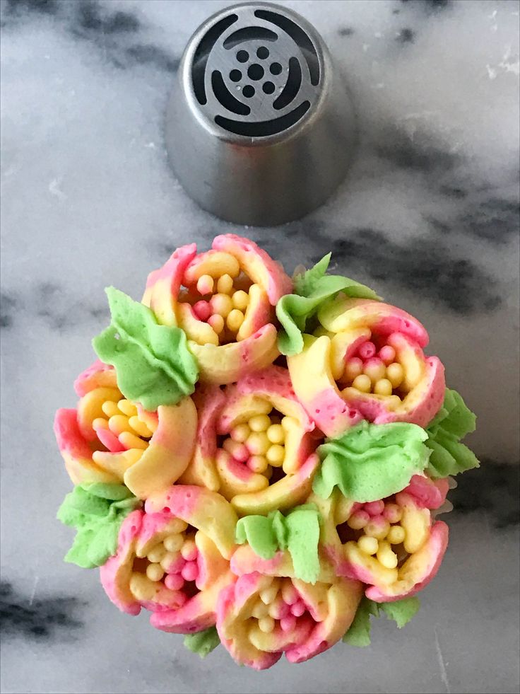 a bunch of food that is on top of a marble table with a canister in the background