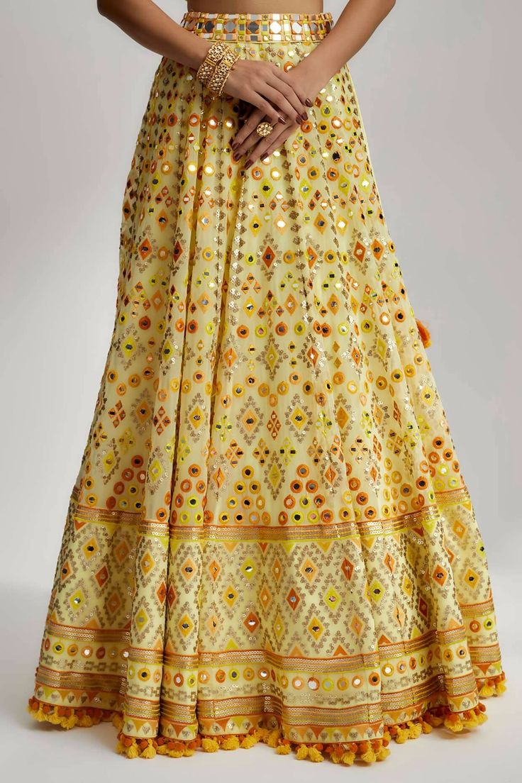 The Esha Lehenga also boasts detailed hand and machine embroidery, showcasing exquisite craftsmanship. Skilled artisans have meticulously adorned the fabric with intricate patterns and motifs using fine threads, sequins and beads. The combination of hand and machine embroidery adds depth and dimension, elevating the lehenga to a work of art. Festive Embroidered Sharara For Reception, Embroidered Chinon Sharara For Reception, Silk Traditional Wear With Mirror Work For Reception, Transitional Saree With Mirror Work Embroidery, Navratri Embroidered Anarkali Set For Reception, Navratri Reception Embroidered Anarkali Set, Embroidered Sharara With Traditional Drape For Transitional Season, Embroidered Saree Fabric With Mirror Work For Reception, Festival Silk Thread Sharara