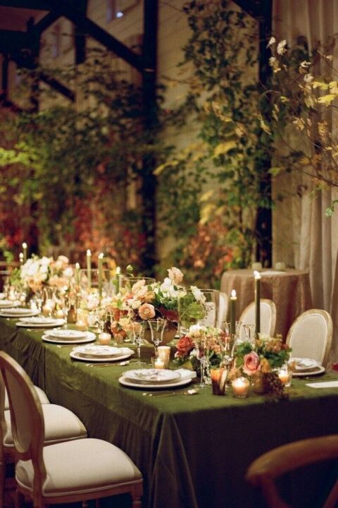 a long table is set with candles and flowers for an elegant dinner or party event