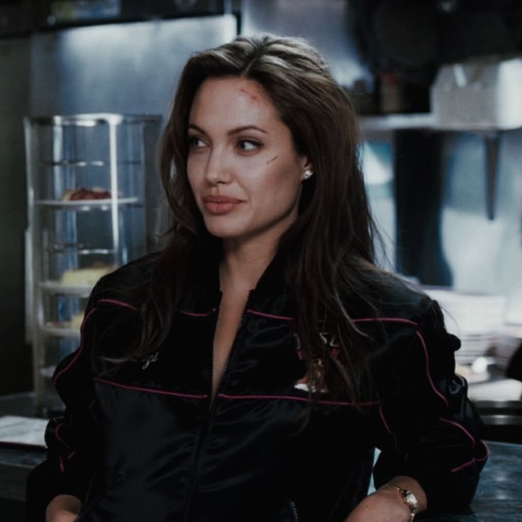 a woman sitting at a counter in a kitchen