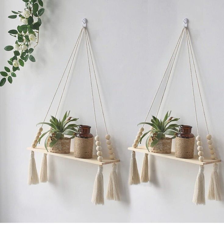 two hanging planters with plants on them