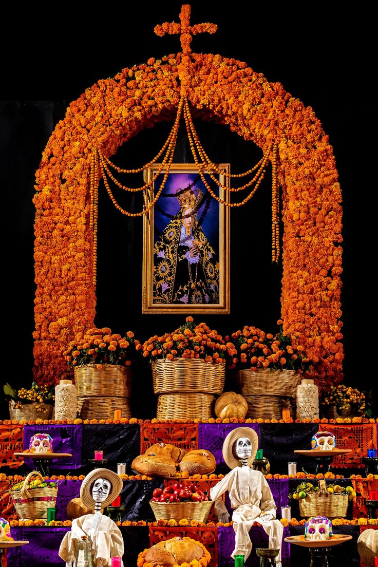 an altar decorated with flowers and skeletons for dia de los muerts day of the dead